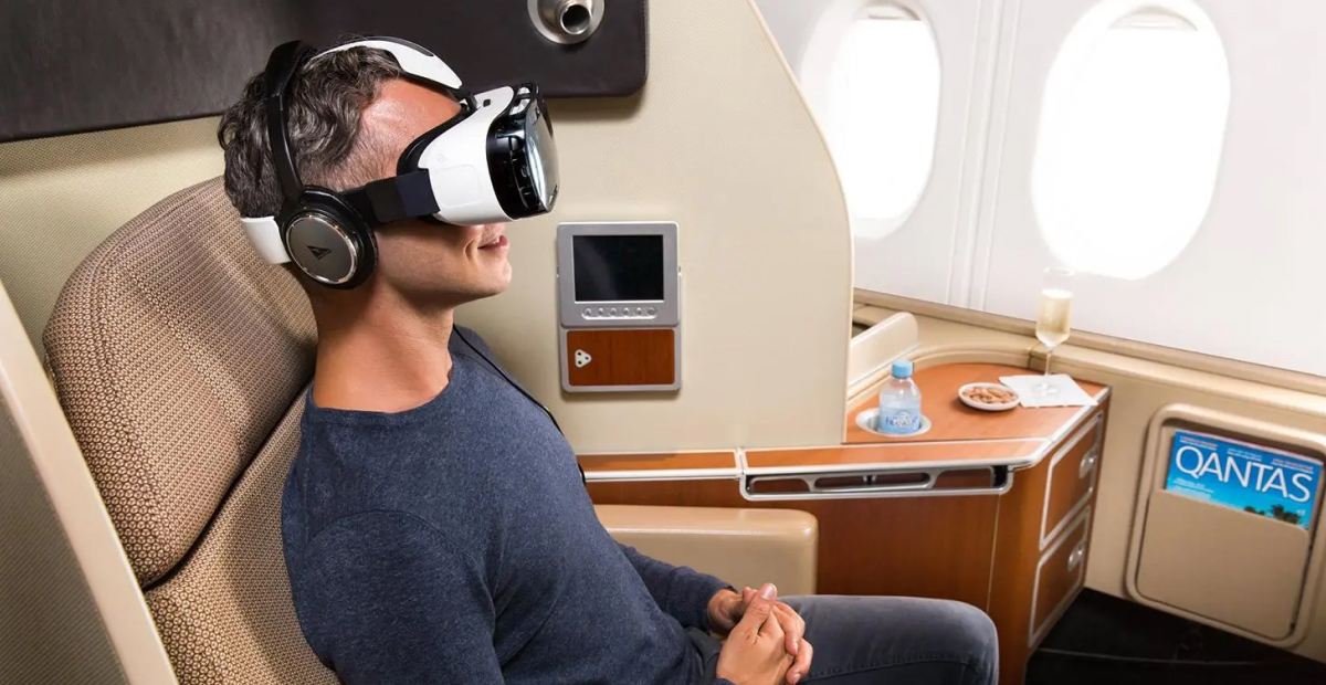 Passenger using advanced VR headset and high-tech in-flight entertainment system in business class