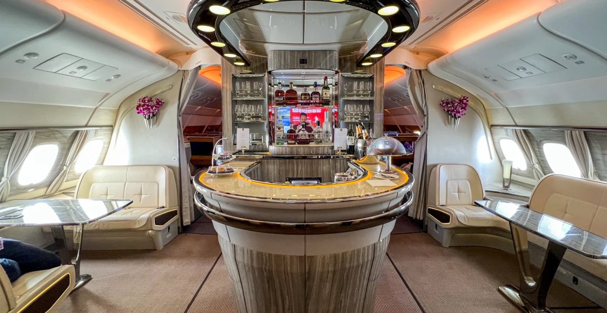 Emirates' luxurious onboard social lounge with a bar on an airplane